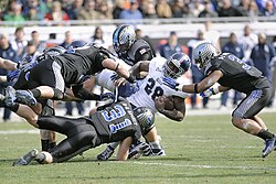 A collegiate-level game of American football, the most popular sport in the U.S.