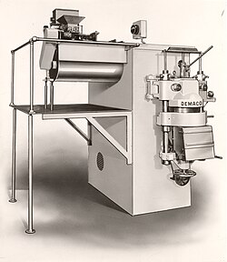 Early model pasta extruder with ingredient proportioning, dough mixing, kneading auger, die holding and product cutting in one machine