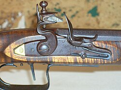 A gun-flint mounted in the jaws of a flintlock musket