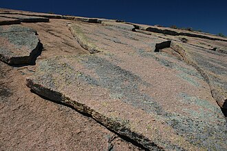Exfoliation joints in granite at Enchanted Rock State Natural Area, Texas, US. Detached blocks have slid along the steeply-dipping joint plane.