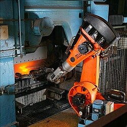 An articulated industrial robot operating in a foundry