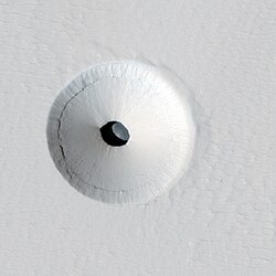 Cropped version of a HiRISE image of a lava tube skylight entrance on the Martian volcano Pavonis Mons