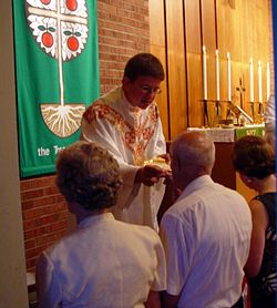A Lutheran pastor wearing a chasuble during communion