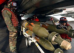 Aviation ordnancemen loading GBU-12 bombs in 2005