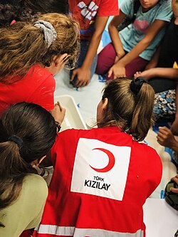A Turkish Red Crescent staff conducting activities for children
