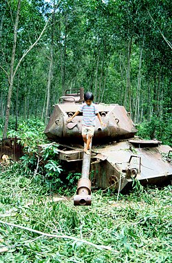 A child plays on an abandoned M41 tank outside Phnom Penh, Cambodia in 1991