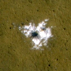 Water ice excavated by an impact crater that formed between January and September 2008. The ice was identified spectroscopically using CRISM.