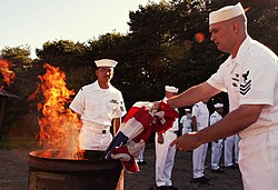 A proper and respectful manner of disposing of a damaged flag is a ceremonial burning (as seen here at Misawa Air Base)