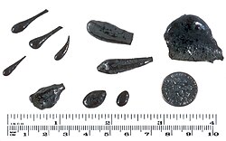 Assorted shapes of Pele's tears from Mauna Ulu. U.S. dime for scale in lower right.