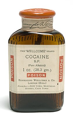 A container of Wellcome-brand cocaine, containing 1 avoirdupois ounce or 28.3 grams (note the non-standard abbreviation gm.).