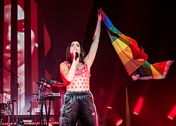 Lipa raising an LGBT flag in a presentation at the Hollywood Palladium in Los Angeles in 2018[298]