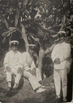 Native Micronesian teaching assistant (left) and constables (middle and right) of Japanese Truk Island, circa 1930. Truk became a possession of the Empire of Japan under a mandate from the League of Nations following Germany's defeat in World War I.[6]