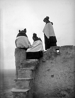 Hopi girls watching Pueblo dancers below, 1906