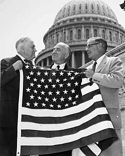 Bob Bartlett and Ernest Gruening, Alaska's inaugural U.S. Senators, hold the 49-star U.S. Flag after the admission of Alaska as the 49th state.