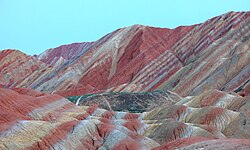 Different colors caused by the different minerals in tilted layers of sedimentary rock in Zhangye National Geopark, China