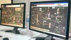 Chemical engineers use computers to manage automated systems in production plants.