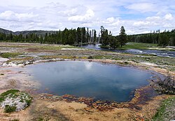 Black Opal Spring in Yellowstone National Park in the United States. Yellowstone, the world's second official protected area (after Mongolia's Bogd Khan Mountain), was declared a protected area in 1872,[31] and it encompasses areas which are classified as both a National Park (Category II) and a Habitat Management Area (Category IV).[32]