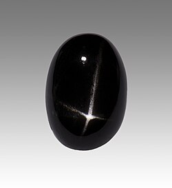 Black cabochon with light star from India