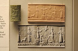 Akkad-period cylinder seal and its modern impression depicting the god Ea in his current form, with the horned tiara symbolizing the divinity and the waters gushing above his shoulders indicating his function as god of underground fresh waters, alongside his vizier Ushmu (right) and the deities Ishtar and Shamash (left). British Museum, London.