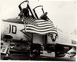 U.S.M.C. pilot Ed McGaa (Eagle Man) and his co-pilot unfurl the US flag on their F-4B Phantom fighter jet.