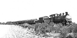 A Western Australian Government Railways E class steam locomotive hauling the first train of bulk wheat in Western Australia, 1931
