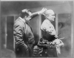 Caruso, examining a bust sculpture of himself, 1914