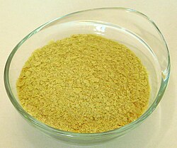 Nutritional yeast flakes are yellow in colour