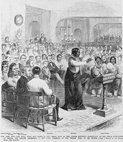 Original caption: “Red Cloud, in the Great Hall of the Cooper Institute, surrounded by the Indian delegation of braves and squaws [sic], addressing a New York audience on the wrongs done to his people”
