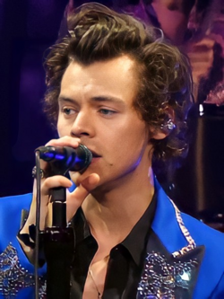 Close up of Harry Styles, with a microphone