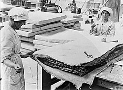 Workers making asbestos insulation for the boilers of navy vessels in 1918, before asbestos was widely recognized as hazardous. Many miners and factory workers suffered early deaths from asbestos-related diseases. The first industry regulations did not come into effect until 1932.