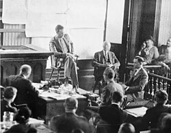 Lindbergh testifying at the Richard Hauptmann trial in 1935. Hauptmann is in half-profile at right.
