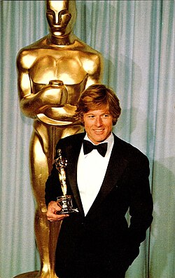 Redford holding an Oscar won at the 53rd Academy Awards in 1981