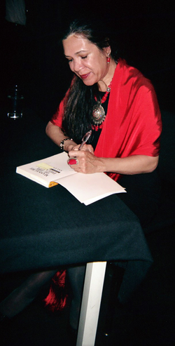 Ana Castillo signing a copy of Massacre of the Dreamers, May 25, 2006