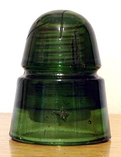 A "Beehive" insulator likely produced by the Brookfield Glass Company; the embossed star was a customer marking.