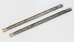 Chinese silver scroll weights embossed with dragons, used to stabilize scrolls when unrolled for viewing.
