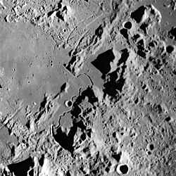 Hadley Rille at center is a sinuous rille visited by the Apollo 15 mission.