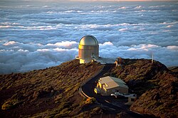 Astronomical observatories are generally situated on mountaintops, as the air at ground level is usually more convective. A light wind bringing stable air from high above the clouds and ocean generally provides the best seeing conditions (telescope shown: NOT).