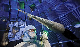 Engineers, scientists and technicians at work on target positioner inside National Ignition Facility (NIF) target chamber