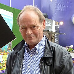 Adams often worked with writer John Lloyd (pictured in 2013); they co-wrote The Meaning of Liff books and two episodes of the Hitchhiker's Guide radio series.