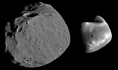 The moons of Mars, Phobos and Deimos. Phobos is the larger of the two moons, and is the closer of the two to Mars. Phobos has an average radius of 11 km, while Deimos has an average radius of 6 km.