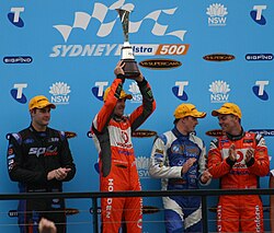 Jamie Whincup (second from left), the most successful driver in the category's history, celebrates winning the 2011 series.