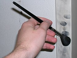 Use of fine powder and brush to reveal latent fingerprints
