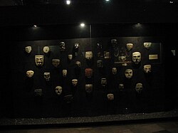 Wall display of stone masks found at the Templo Mayor site on display at the Templo Mayor museum.