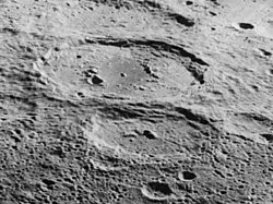 Oblique Lunar Orbiter 5 image facing west of Antoniadi (above center) and Numerov (below center)