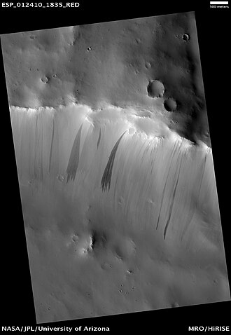 Dark slope streaks are often fan-shaped with multiple fingers (digitation) at their downslope ends. Image is from the HiRISE camera on the Mars Reconnaissance Orbiter.