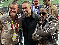 Rubin on the sideline of Mercedes-Benz Stadium with Learfield CEO Cole Gahagan and musician Travis Scott.