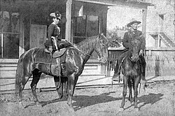 Belle Starr, Fort Smith, Arkansas, 1886; the man on the horse is Deputy U.S. Marshal Benjamin Tyner Hughes who, along with his posse man, Deputy U.S. Marshal Charles Barnhill, arrested her at Younger's Bend in May 1886 and brought her to Ft. Smith for arraignment.