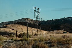 A fire engine approaching smoldering brush at the Tumbleweed Fire near Los Angeles in July 2021