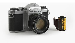 Kodak 35mm film cartridge alongside Asahi Pentax film camera. The shift from film to digital greatly affected Kodak's business.
