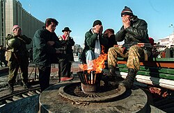 Dudayev's supporters pray in front of the Presidential Palace in Grozny, 1994